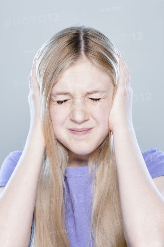 Portrait of teenage girl (14-15), studio shot. 
Photo: Rob Lewine