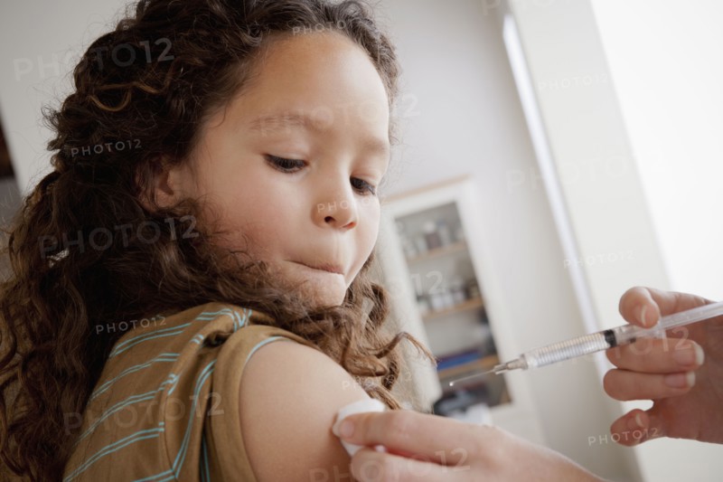 Girl (8-9) having vaccination. 
Photo : Rob Lewine