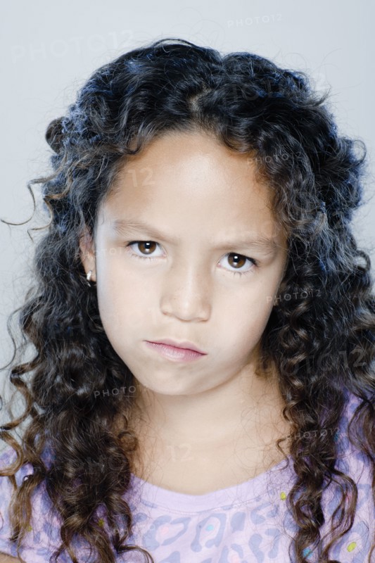 Portrait of confused girl (8-9), studio shot. 
Photo : Rob Lewine