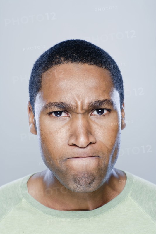Portrait of young angry man, studio shot. 
Photo: Rob Lewine