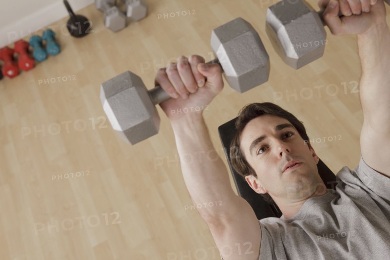 Young man exercising with dumbbell. 
Photo : Rob Lewine