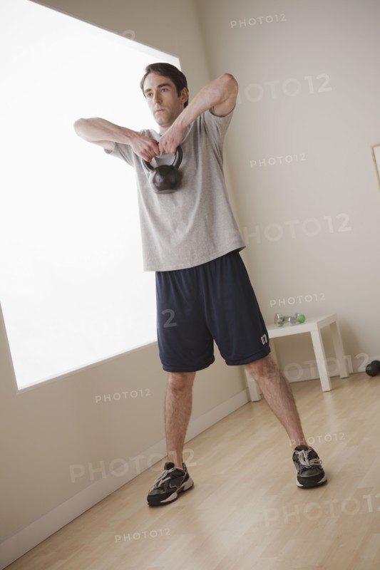 Young man exercising with weight. 
Photo: Rob Lewine