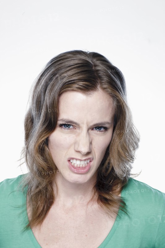 Portrait of angry young woman, studio shot. 
Photo: Rob Lewine