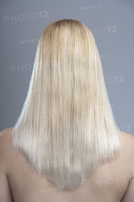 Rear view of woman with blonde hair, studio shot. 
Photo : Mark de Leeuw