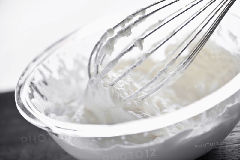 Whisking cream, studio shot. 
Photo: Elena Elisseeva
