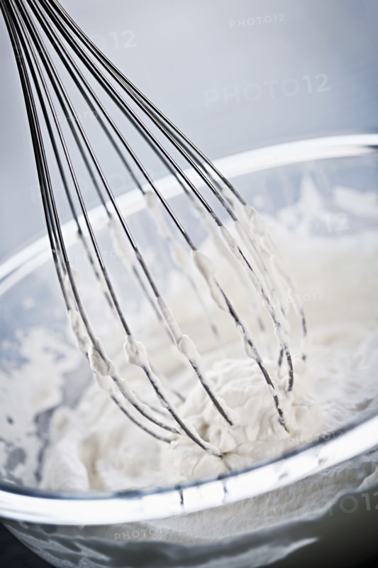 Whisking cream, studio shot. 
Photo: Elena Elisseeva