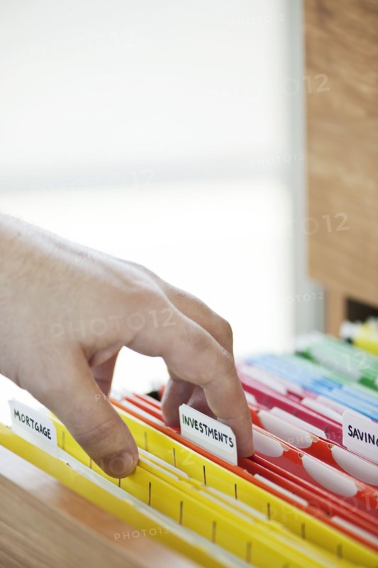 Hand searching in files drawer. 
Photo : Elena Elisseeva