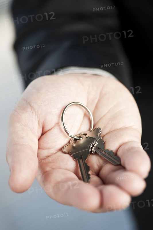 Home keys on hand, studio shot. 
Photo: Elena Elisseeva