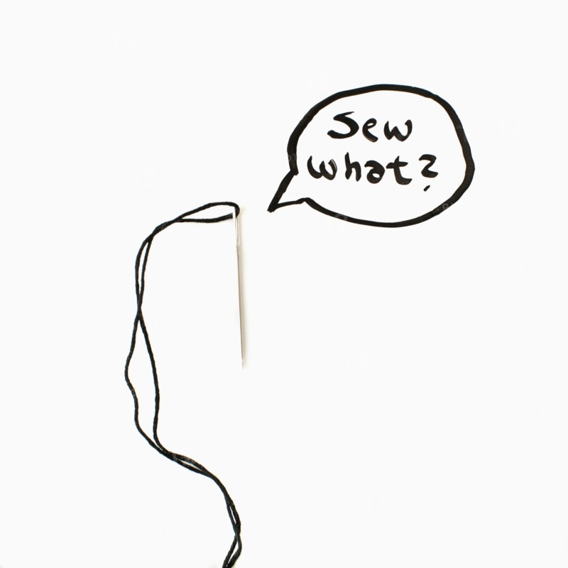 Needle and thread with text in speech bubble, studio shot. 
Photo: Jessica Peterson