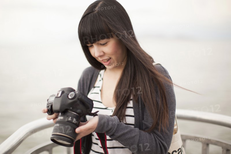 Young woman checking photos in camera. 
Photo: Jessica Peterson