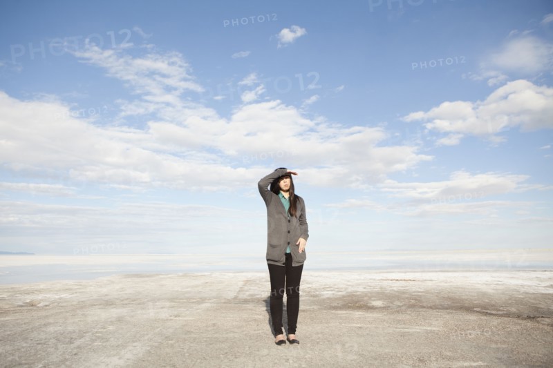 USA, Utah, Salt Lake City, Young woman standing on desert and looking away. 
Photo: Jessica Peterson
