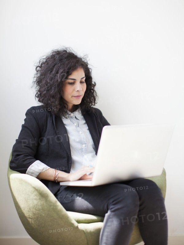 Studio shot of young woman using laptop. 
Photo: Jessica Peterson