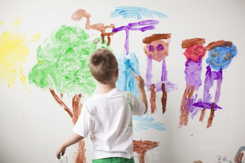 Toddler boy (2-3) painting on wall. 
Photo: Jessica Peterson