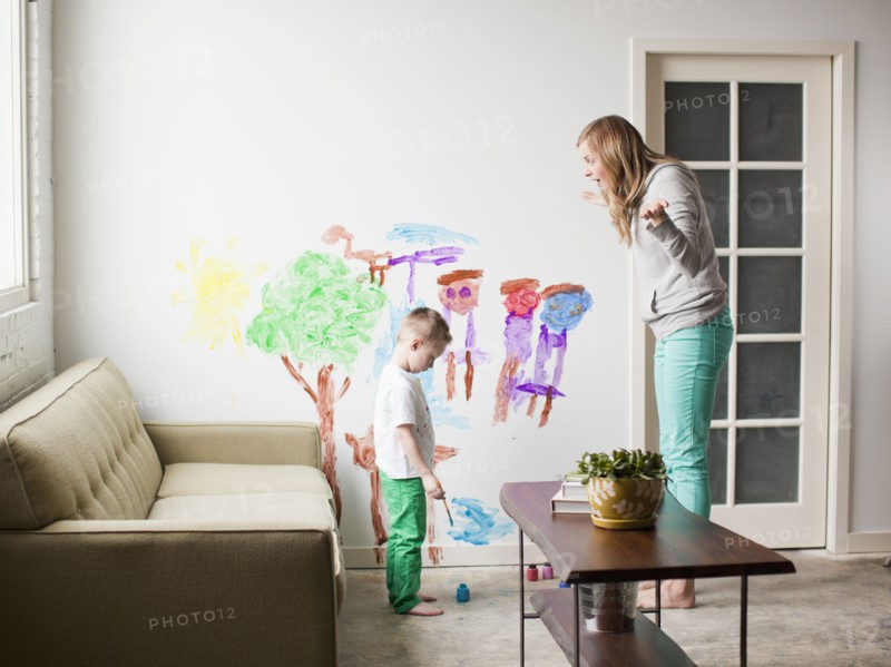 Mother telling toddler boy (2-3) off for painting on walls. 
Photo: Jessica Peterson