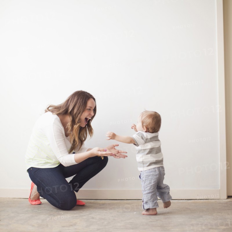 Young mother assisting baby boy (6-11 months) in first steps. 
Photo: Jessica Peterson