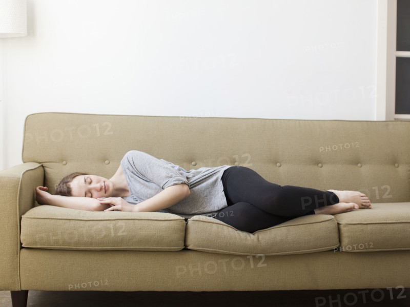 Young woman sleeping on sofa. 
Photo : Jessica Peterson
