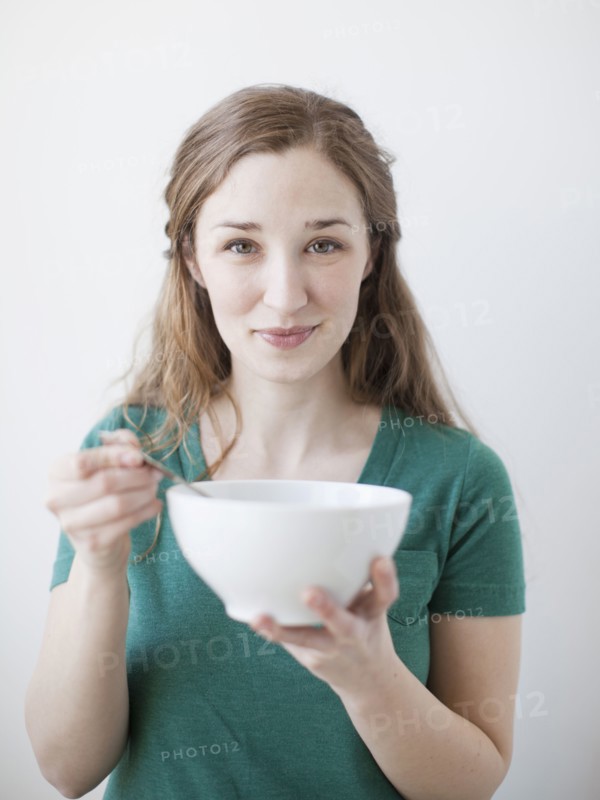 Happy young woman enjoying bowl of cornflakes. 
Photo : Jessica Peterson