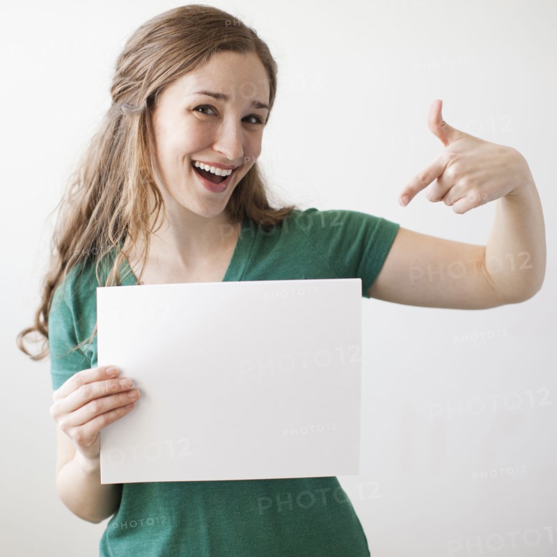 Portrait of young attractive woman holding blank sheet of paper. 
Photo: Jessica Peterson