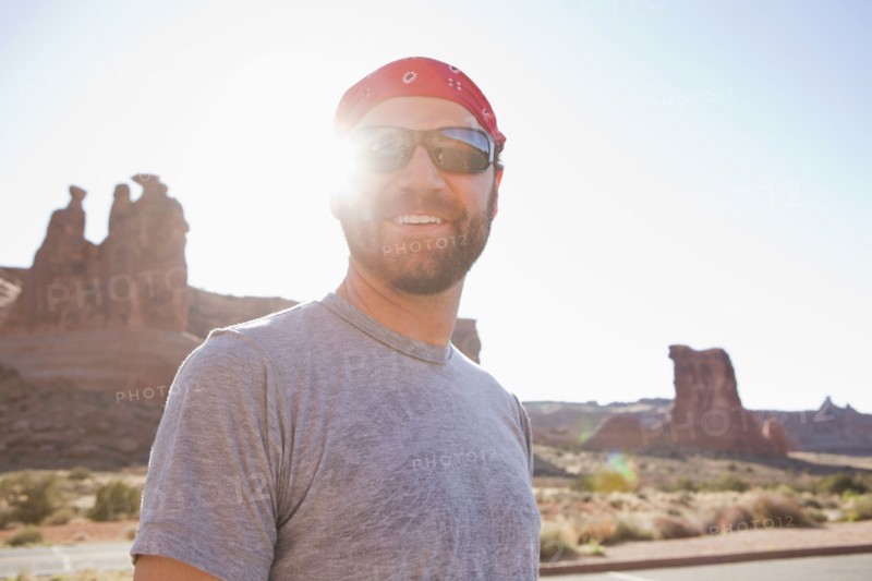 USA, Utah, Moab, Mid adult man posing in cycling gear. 
Photo : Jessica Peterson