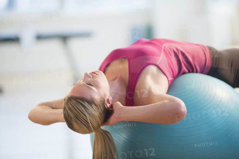 Woman exercising on fitness ball.