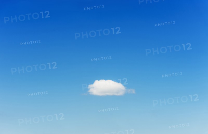 Blue sky with single cloud.