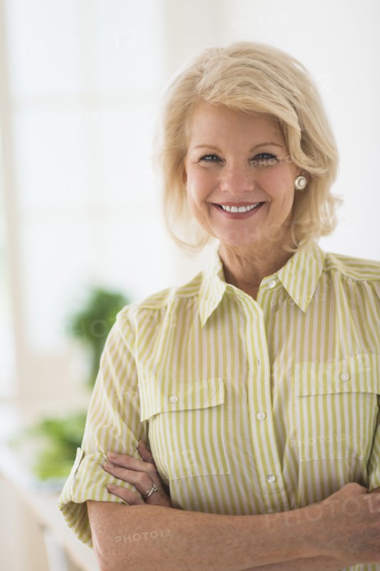 Portrait of mature woman in kitchen.