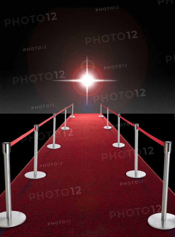 Glowing star above red carpet.