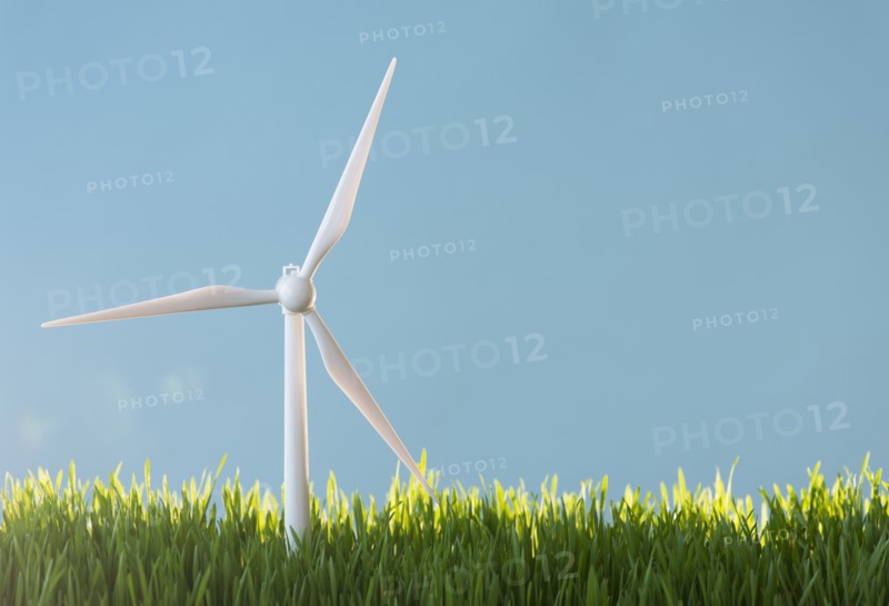 Model wind turbines in grass.