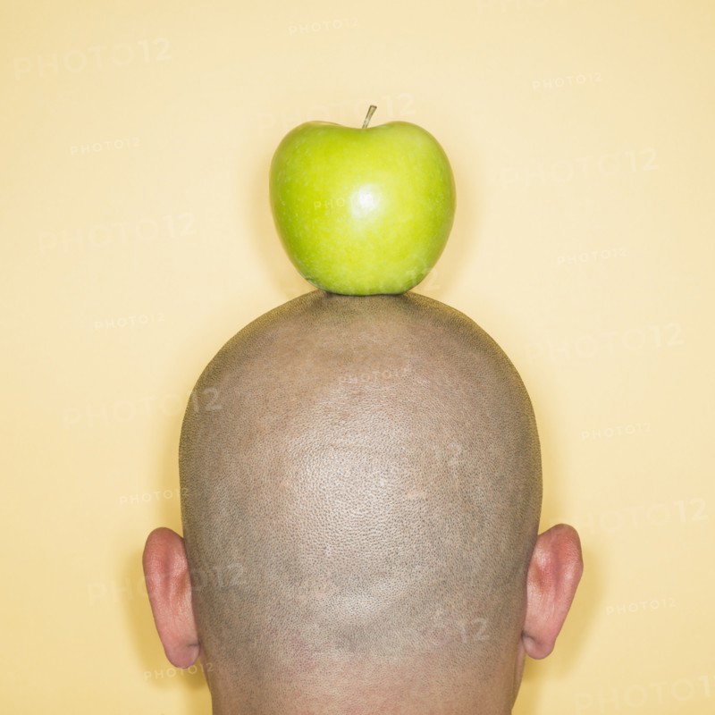Back view of man with apple on head.