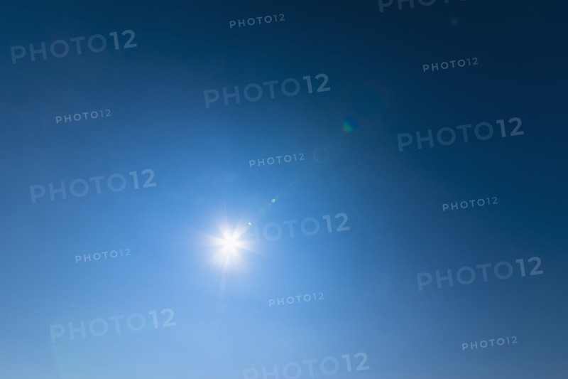 Blue sky lit with bright sunshine.