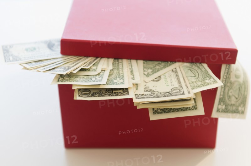US dollar banknotes pouring out from box. Photo: Jamie Grill