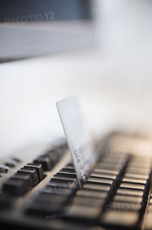 Close-up shot of computer keyboard and credit card. Photo : Jamie Grill