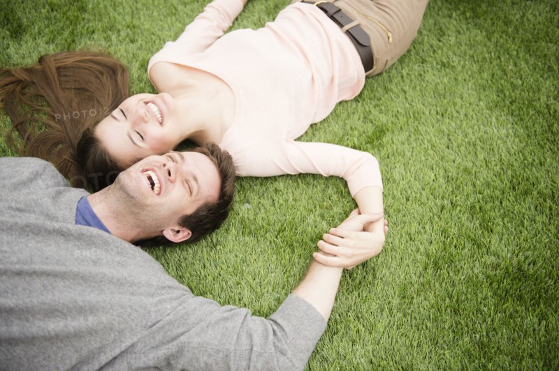 Couple relaxing on grass. Photo : Jamie Grill
