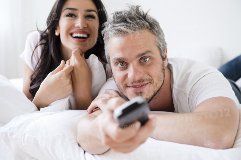 Couple watching television. Photo : Jamie Grill