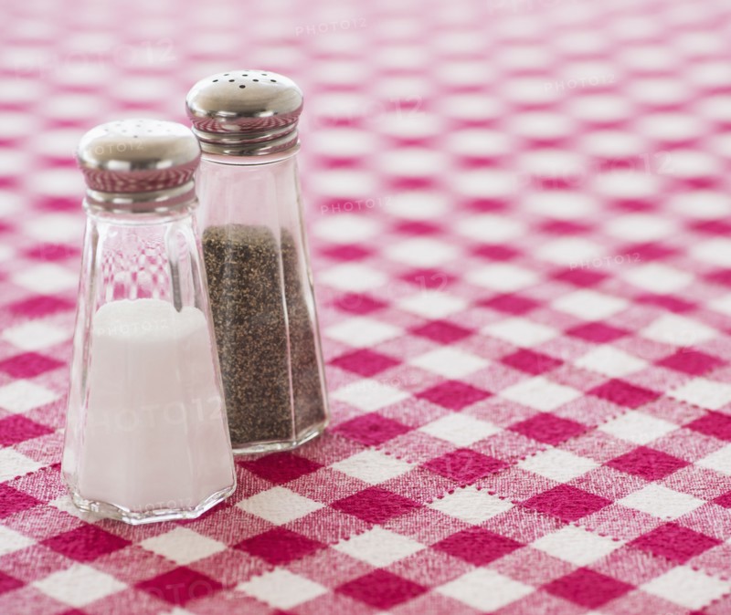 Salt and pepper shakers on checked tablecloth. Photo: Daniel Grill