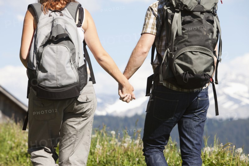 Switzerland, Leysin, Hikers walking and holding hands. Photo: Mike Kemp