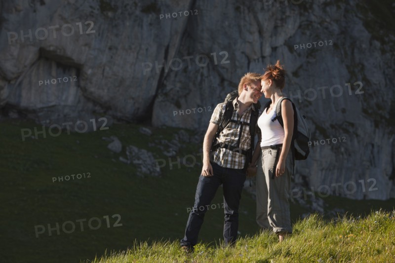 Switzerland, Leysin, Hikers on Alpine meadow. Photo: Mike Kemp