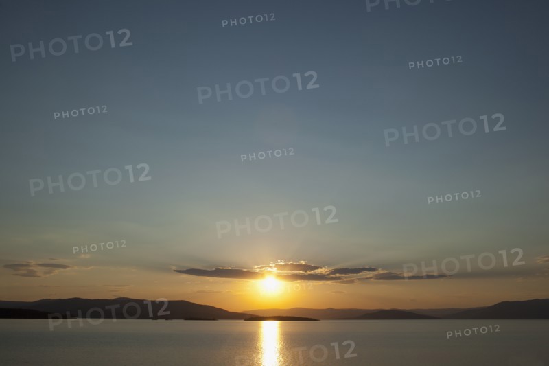 USA, Montana, Flathead Lake, View of sunset over lake. Photo: Noah Clayton