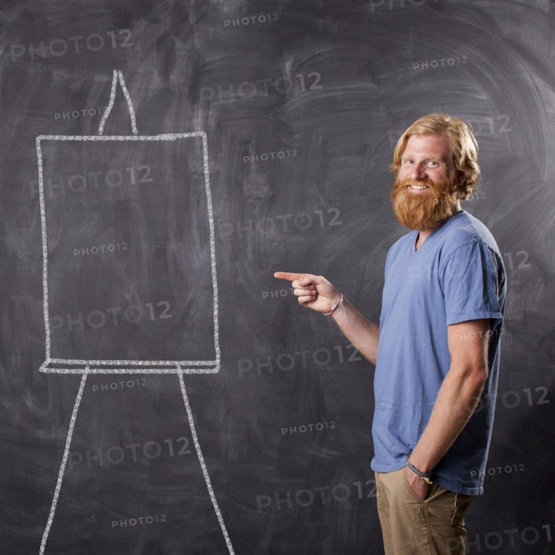 Man in front of blackboard pointing. Photo: Jessica Peterson