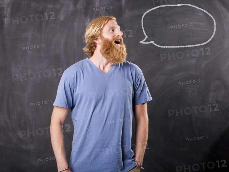 Man in front of blackboard with drawing depicting speech bubble. Photo: Jessica Peterson