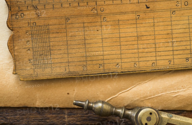 Old brown paper with ruler and compass, studio shot.