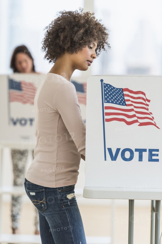 Woman in voting booth.