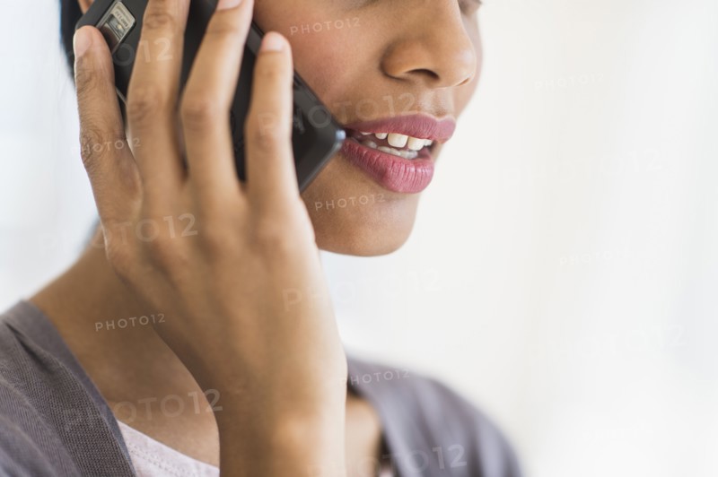 Businesswoman talking on phone, studio shot.
