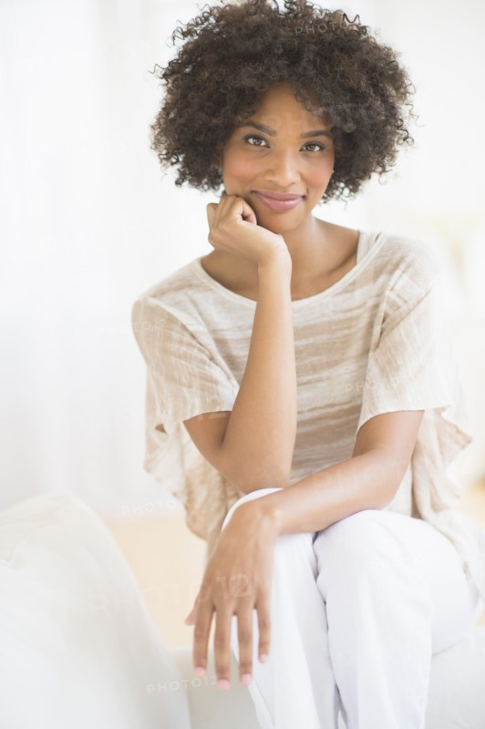 Portrait of woman sitting on sofa.
