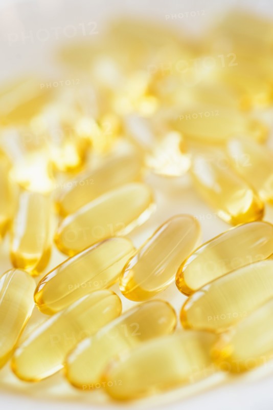 Omega fatty acid pills on white background, studio shot.
