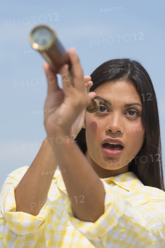 Woman looking through telescope.