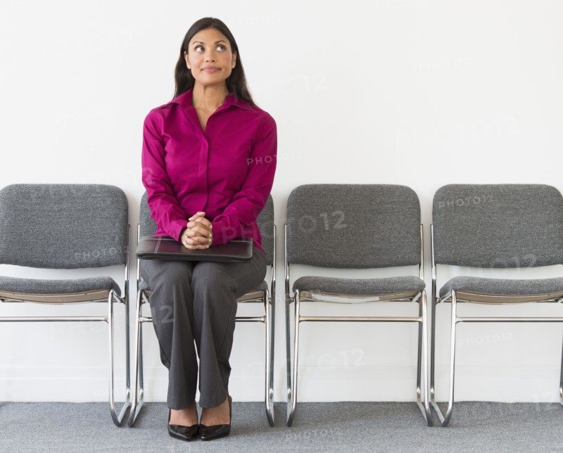 Woman sitting in waiting room.
