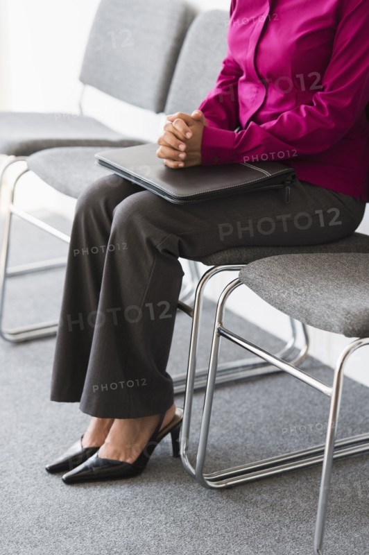 Woman sitting in waiting room.