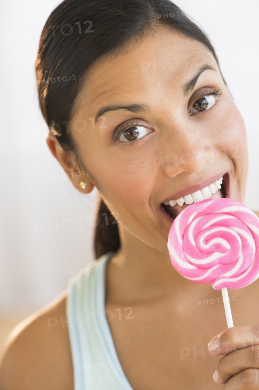 Woman eating lollypop.