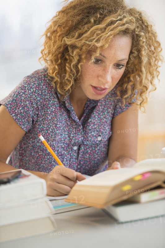 Young woman studying in library.